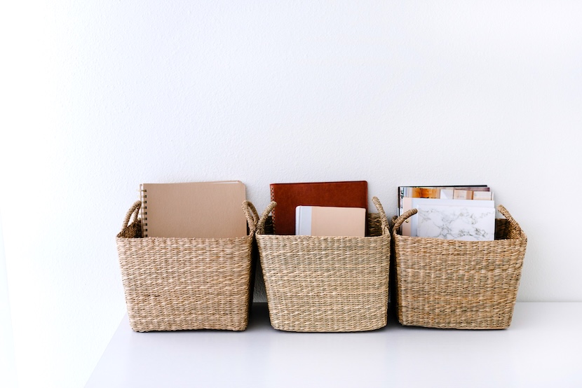 3 woven baskets holding notepads - a tip on how to declutter fast.