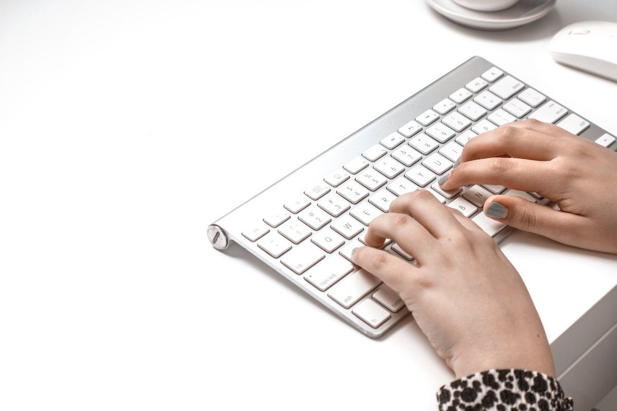 Woman typing on keypad - digital declutter tools.