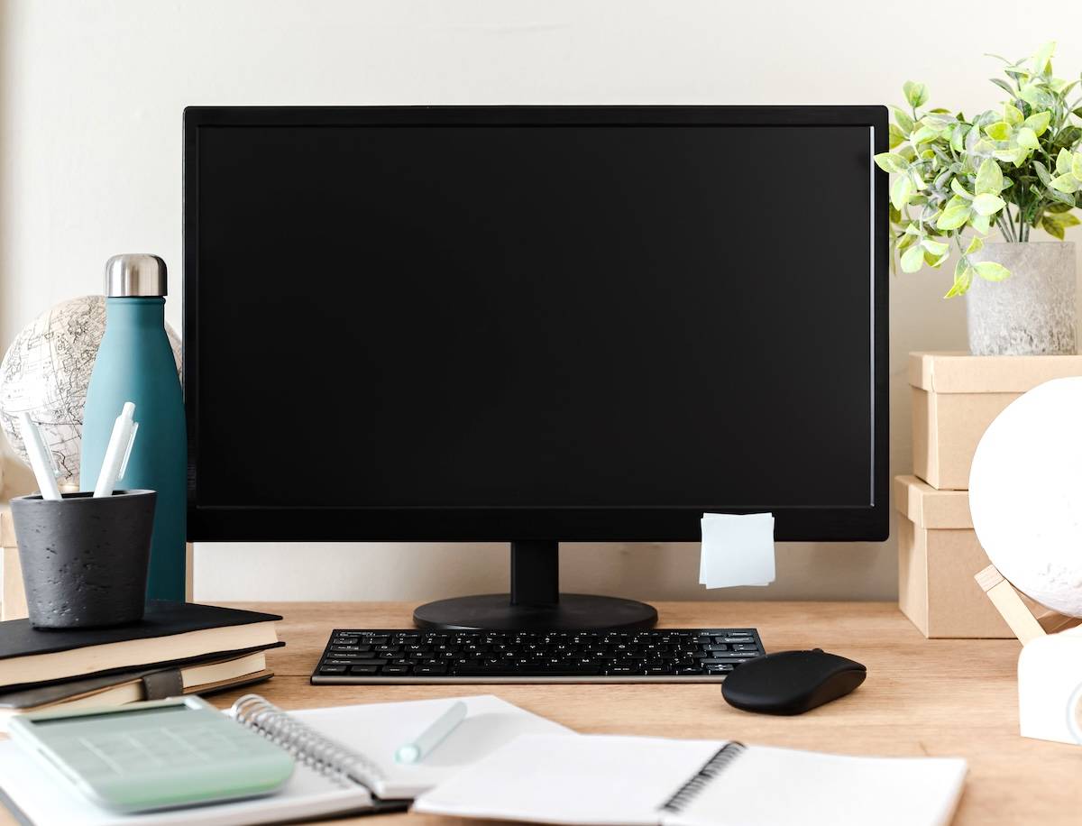 Computer, water bottle, school supplies - a homework station for kids.