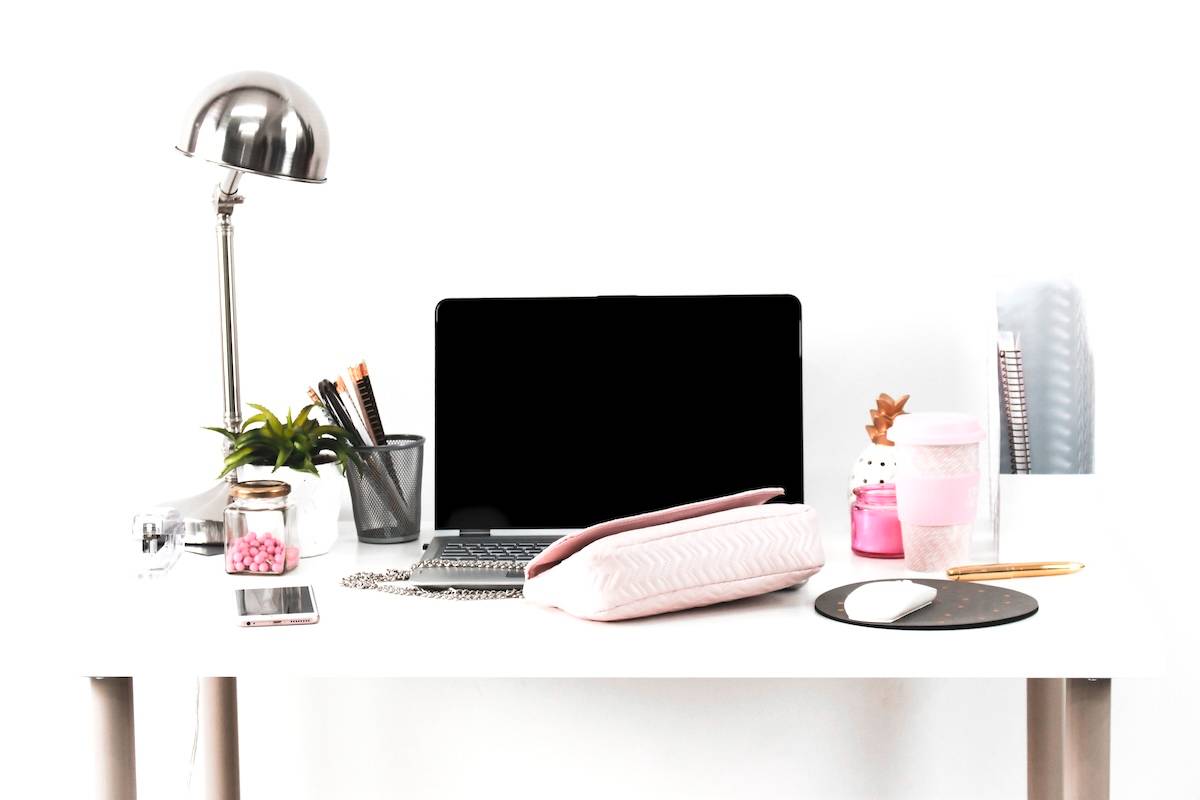 Laptop, coffee, stationery on a desk - things you need to have a productive day.