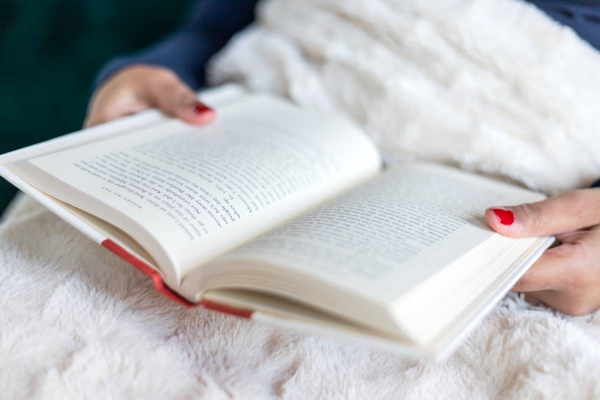 Woman reading - self care routine ideas.