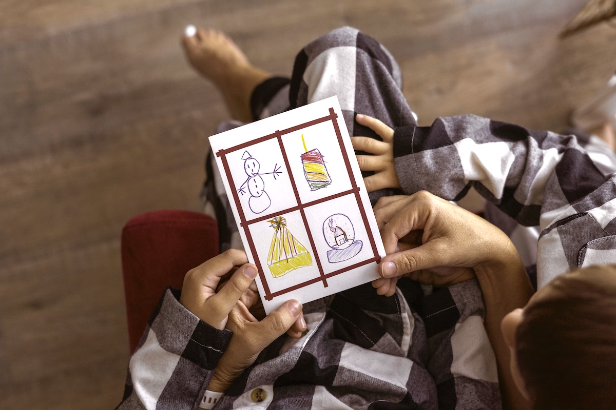 Boy holding a Christmas card - Christmas activities for kids