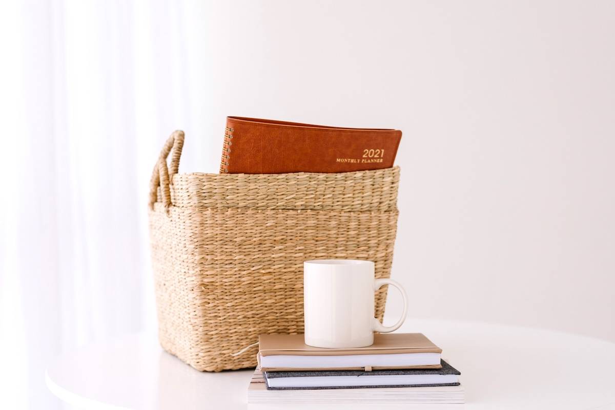 2 baskets, planner, notebooks, coffee cup - items you can declutter for the new year.
