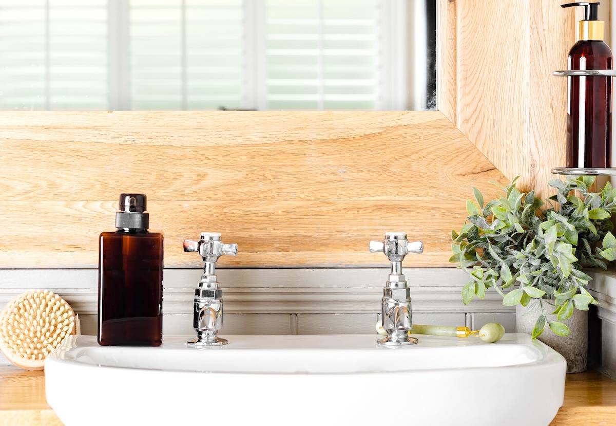 Bathroom sink, soap, plant - bathroom decluttering tips.