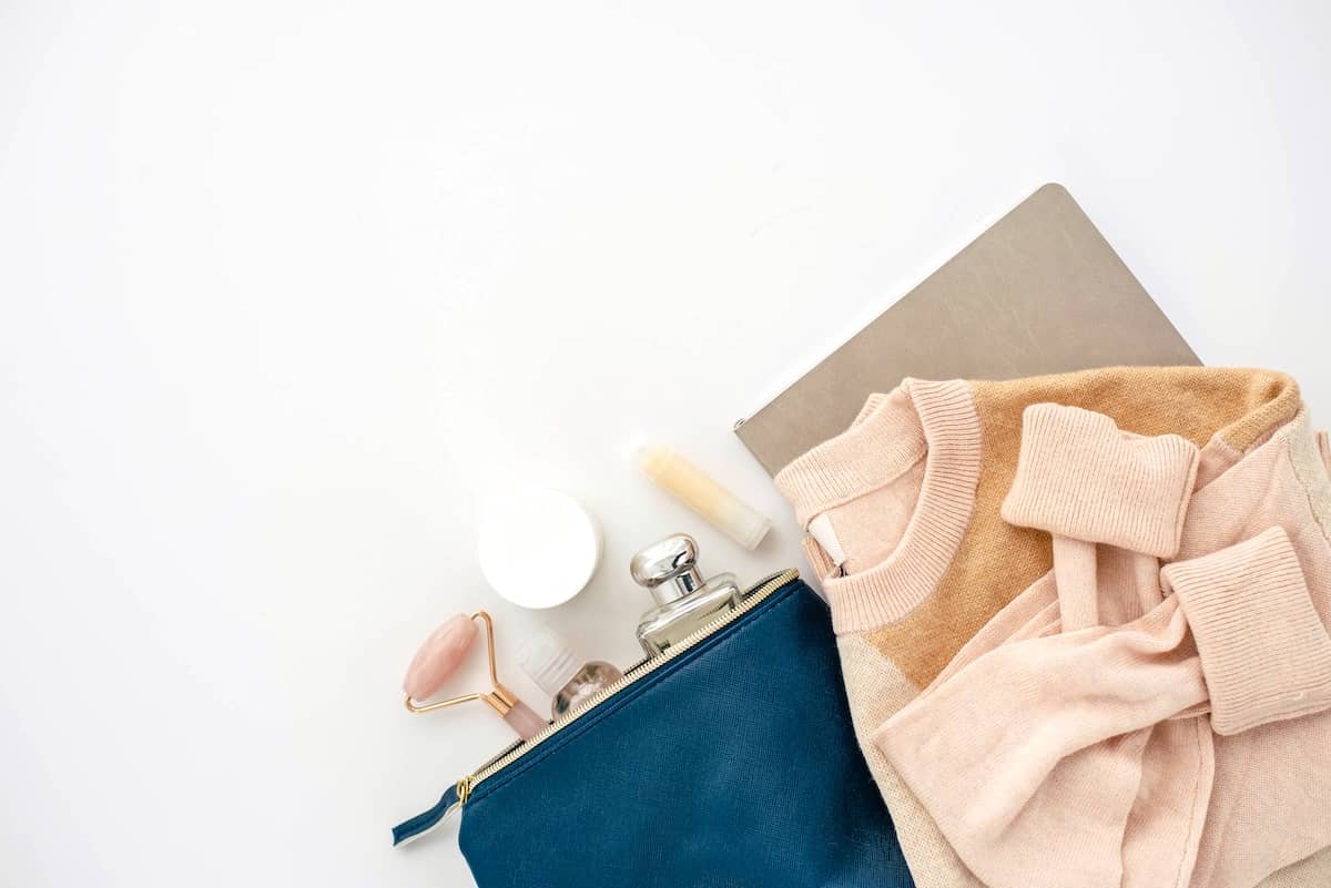 Pile of clothing and makeup - guide to decluttering clothes.