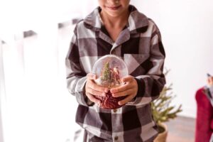 Boy holding snow globe - Christmas stocking stuffers.