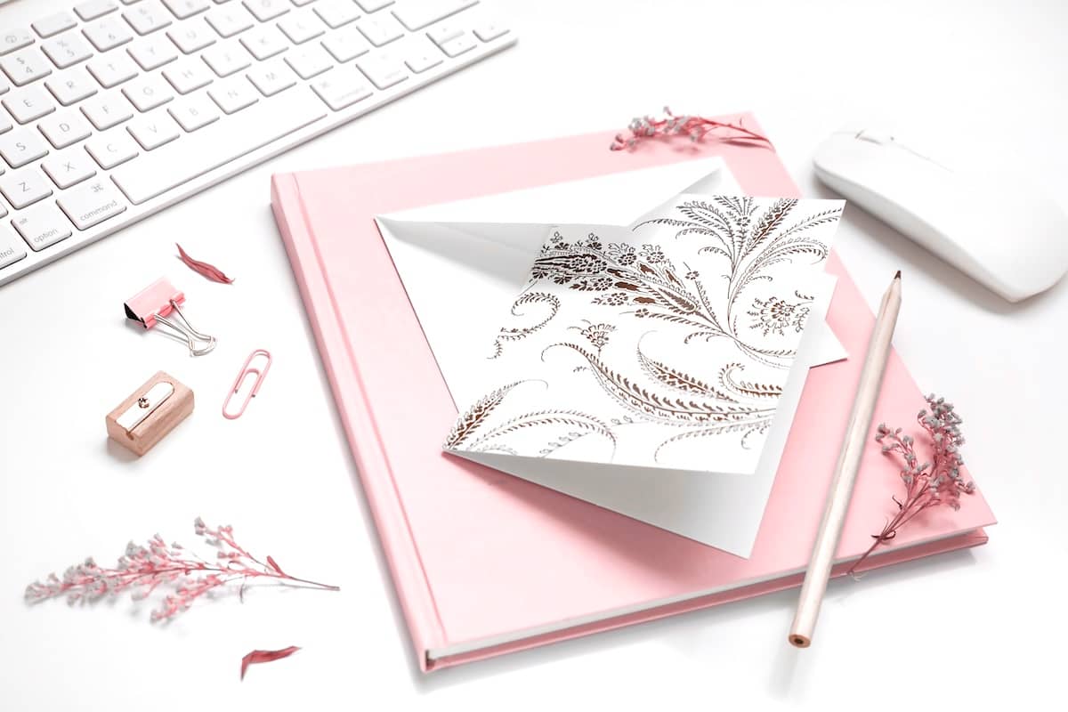 Laptop, pink notebook - time saving tips for mums.