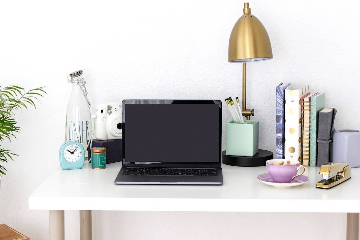 Desk, laptop, lamp, notebooks - how to use family calendars.