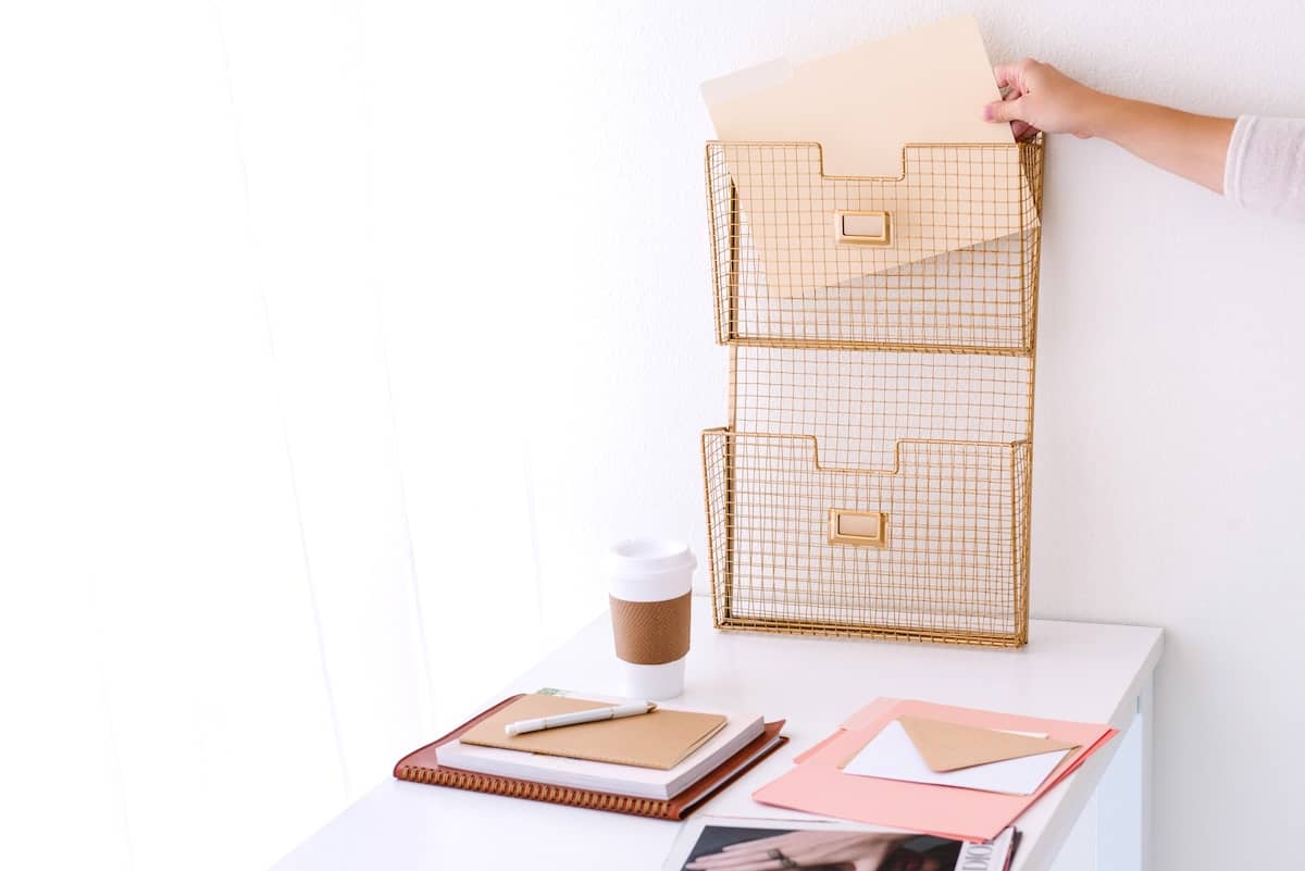 Woman putting file in folder - how to declutter fast.