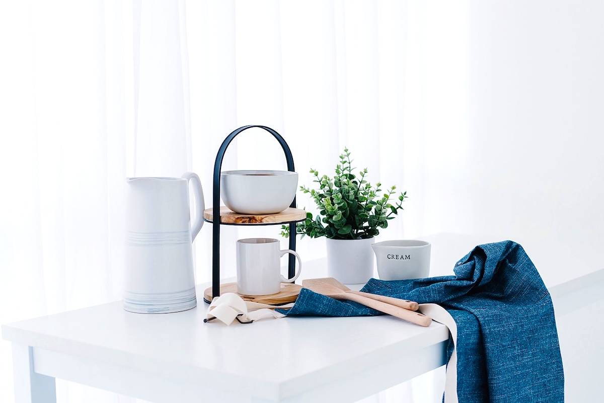 Table, crockery, apron - home reset items.