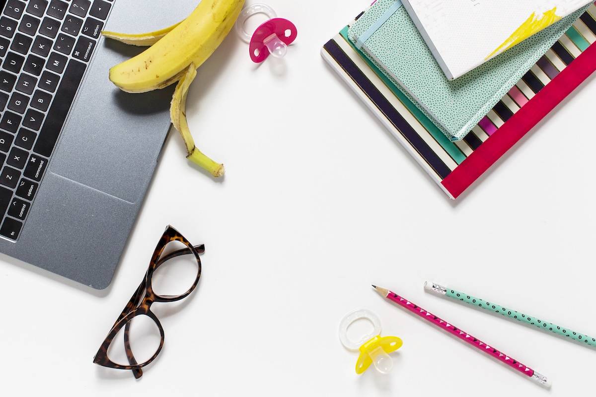 Laptop, books, glasses - items to help to lighten the mental load of motherhood.