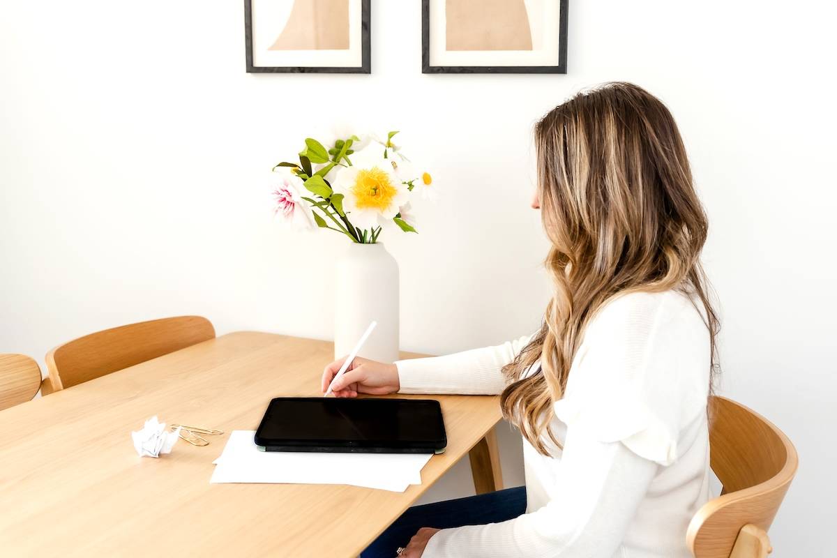 Women writing at desk - some ways to lighten the mental load of motherhood.