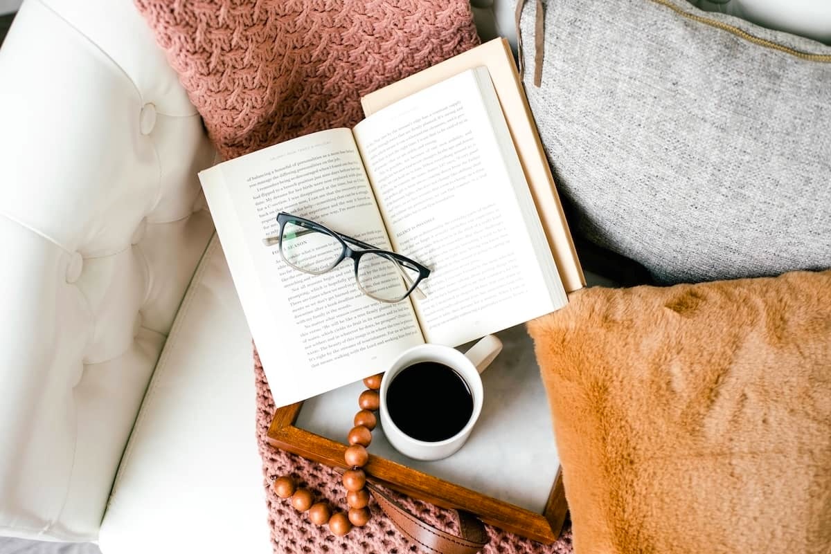 Book and cushions on couch - tips for how to declutter your home.