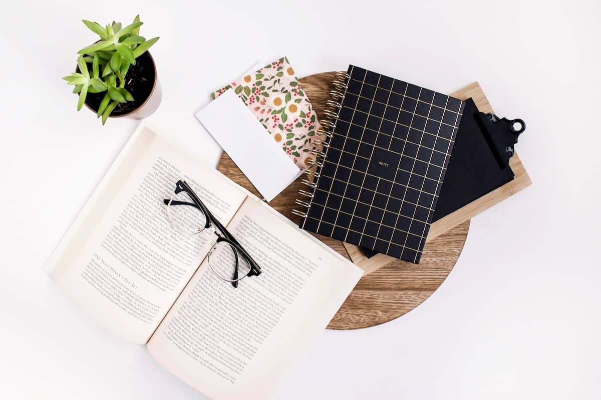 Books and notepads on table - tips for how to declutter your home.