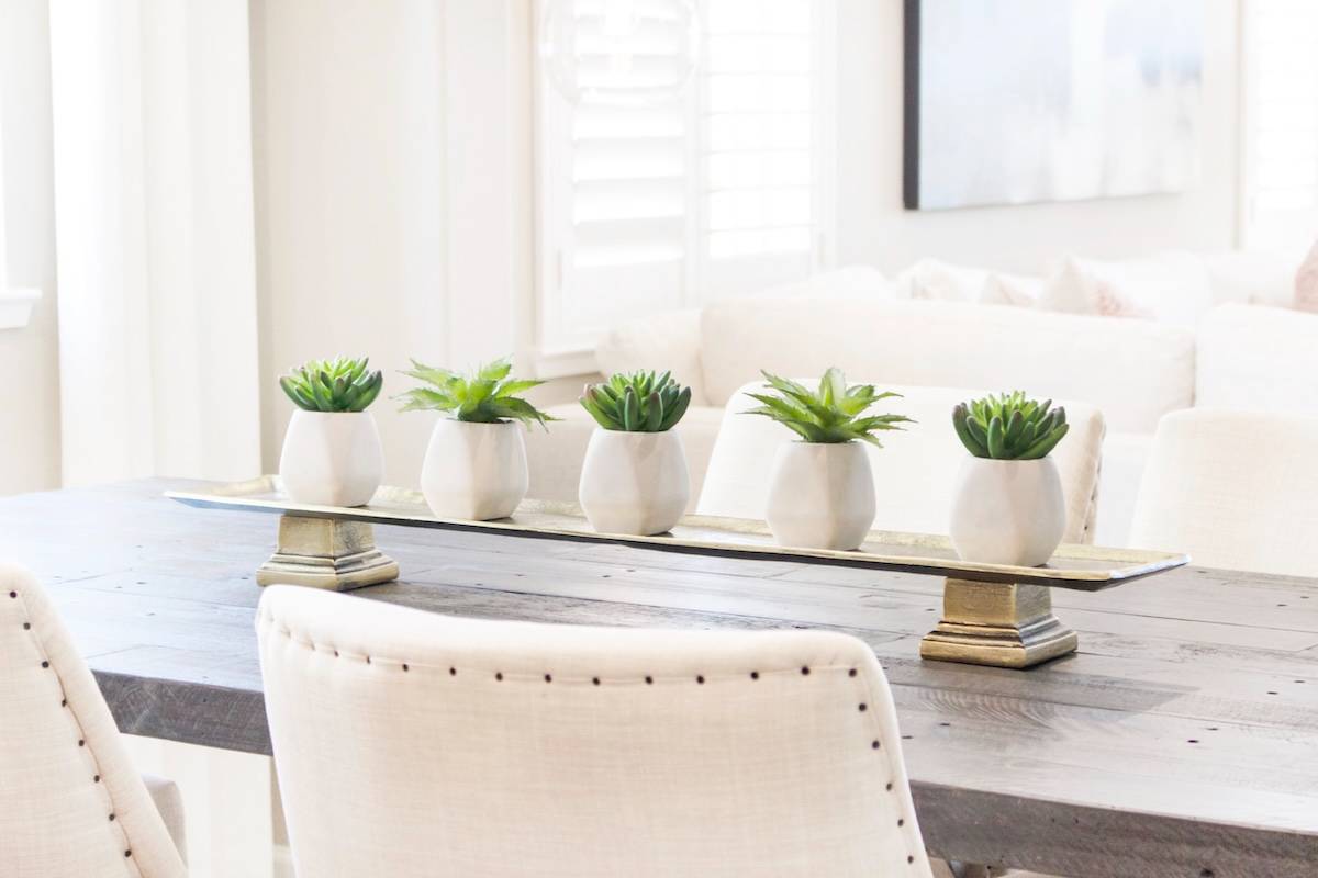 Table with floral centrepiece - home organisation tips for living areas.