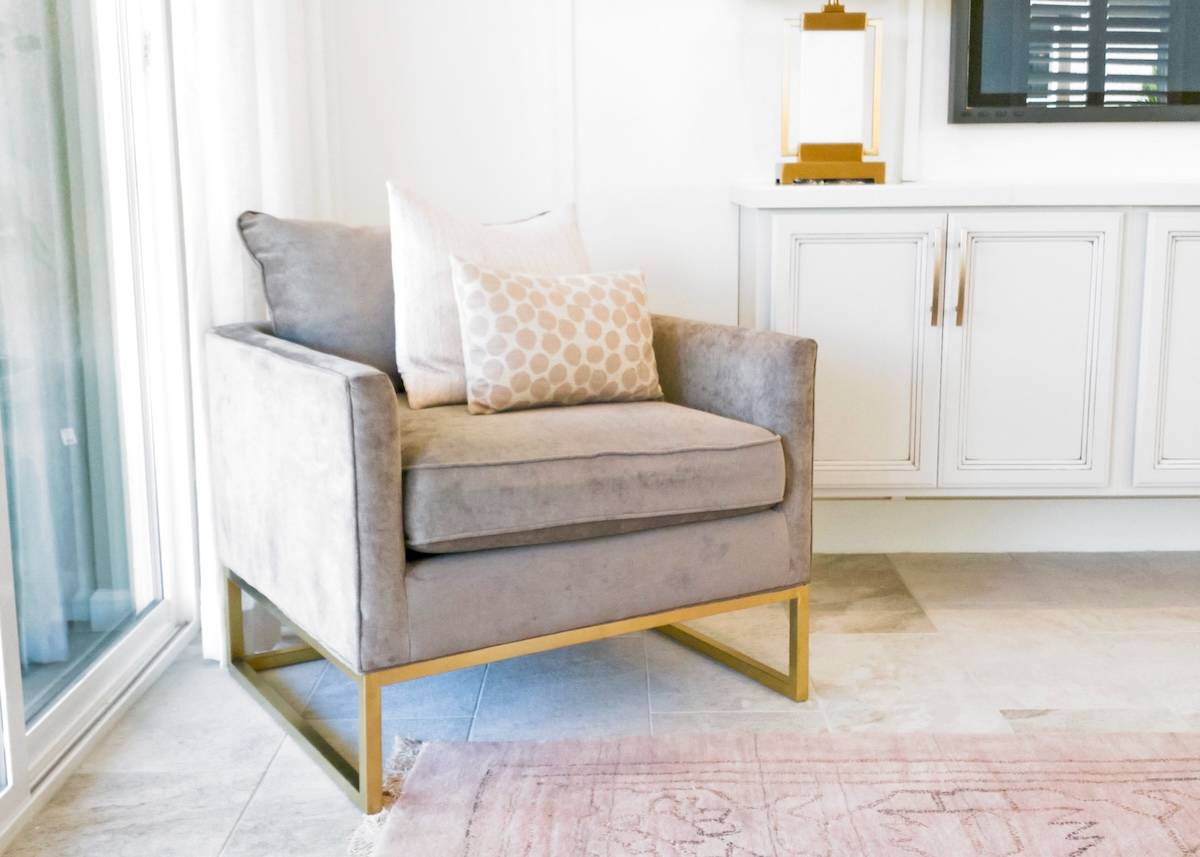 Sofa with cushions - home organisation tips for living areas.