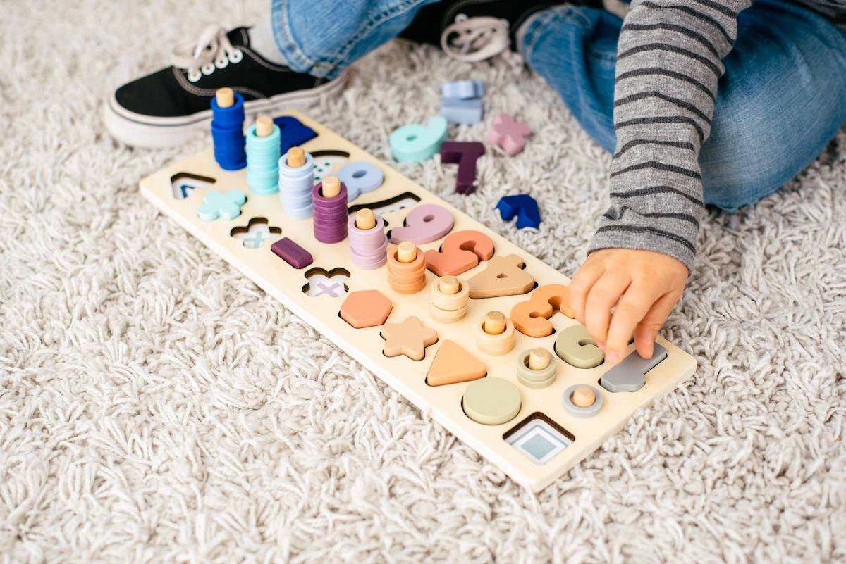 Child doing puzzle - home organisation tips for toys.