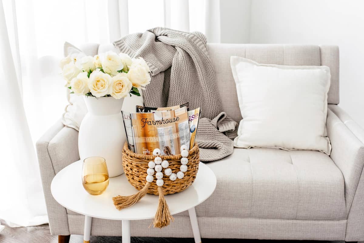 Sofa, table, flowers, magazines - home organisation tips for living areas.