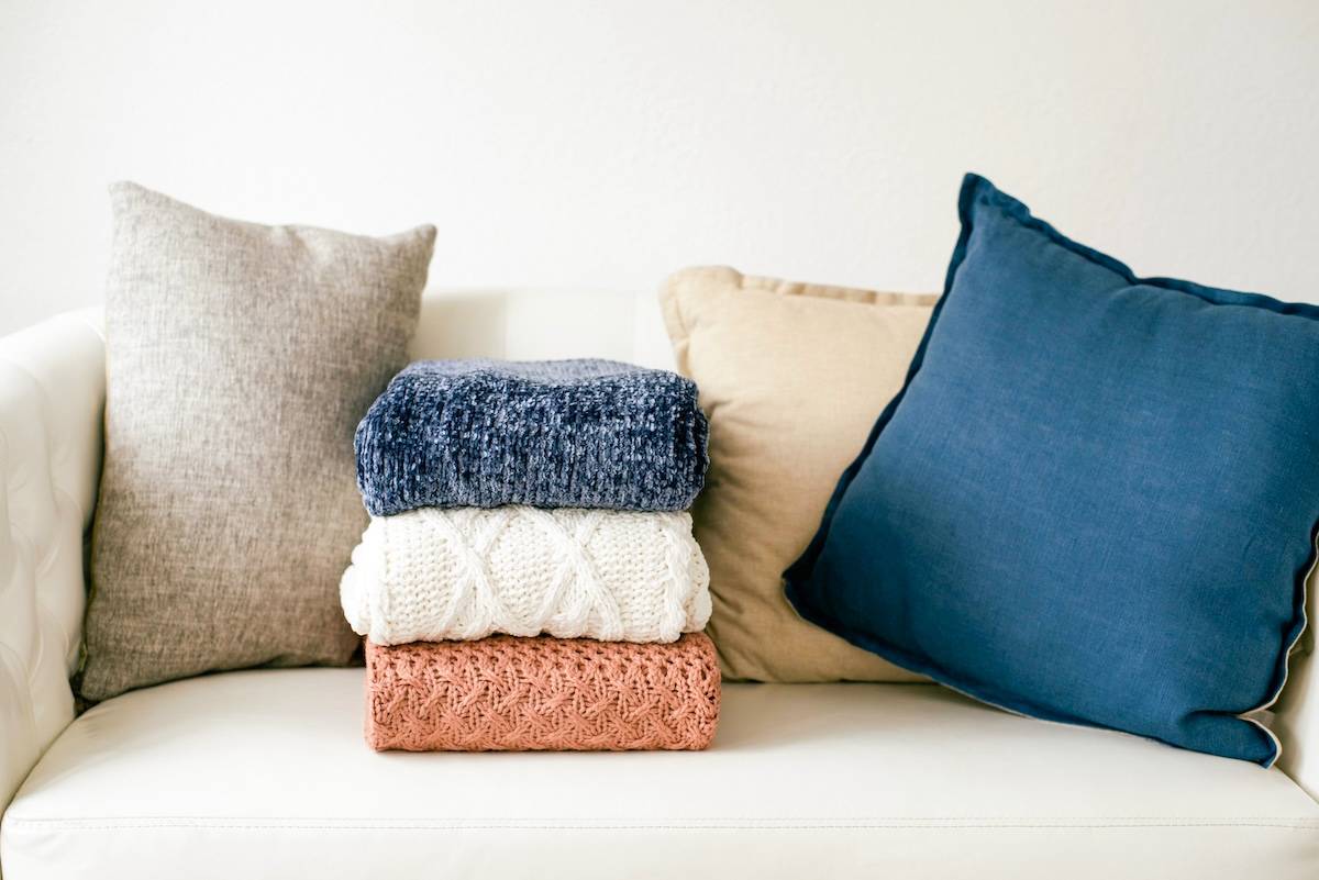 Clothing folded on couch - daily cleaning to try.