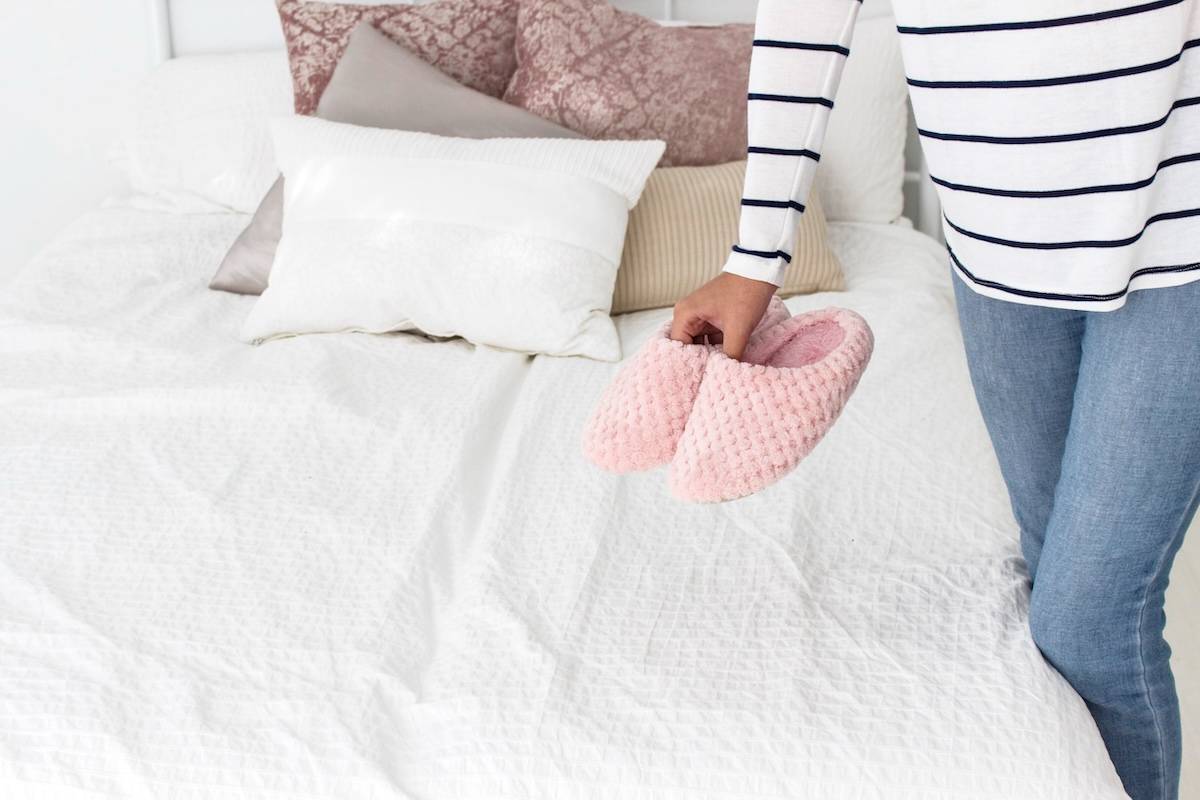 Woman holding slippers - ways to create a simpler home.
