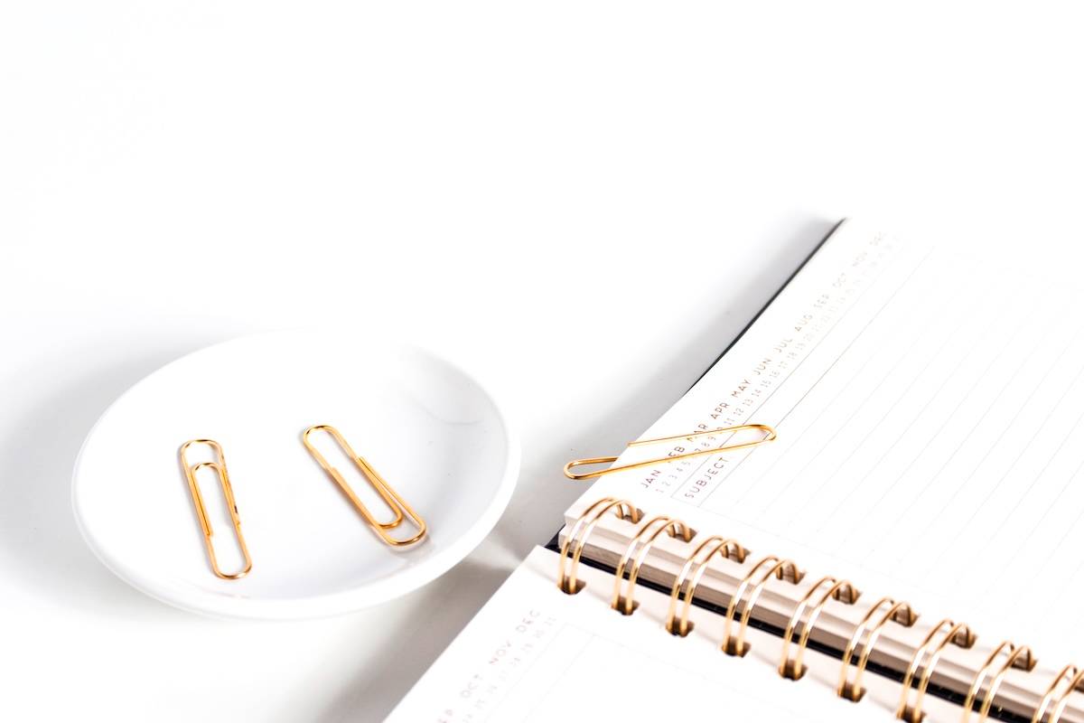 Notebook, paper clips - stationery for school supply organisation ideas.