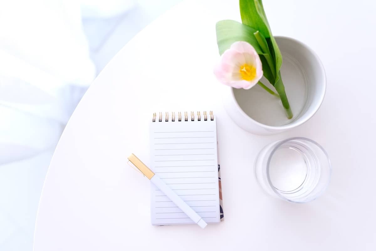 Notebook on table - ideas for a weekly family routine.