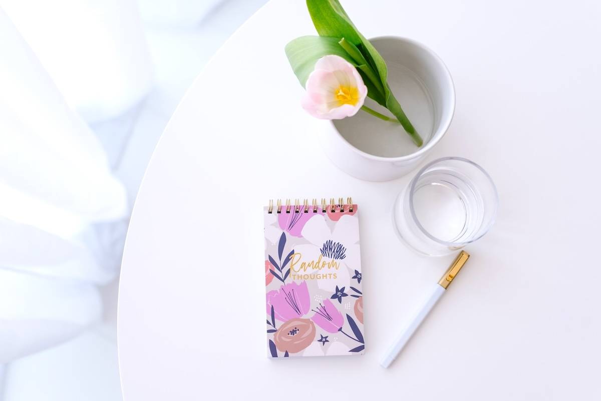 Notebook, pen, water, flower - ideas for a weekly family routine.