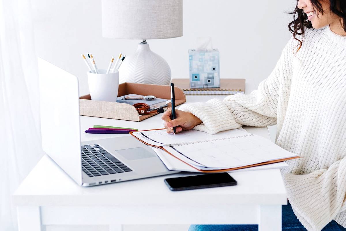 Women writing a list - tips to tackle an overwhelming to-do list.