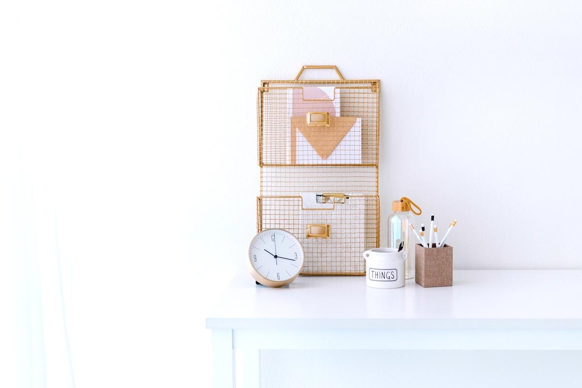 Stationery, paper holder, clock - items to help with an evening reset routine.