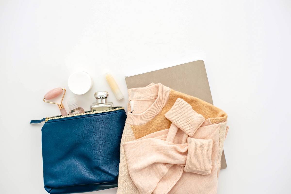 Toiletry bag, jumper, notebook - items needed for a realistic evening routine.