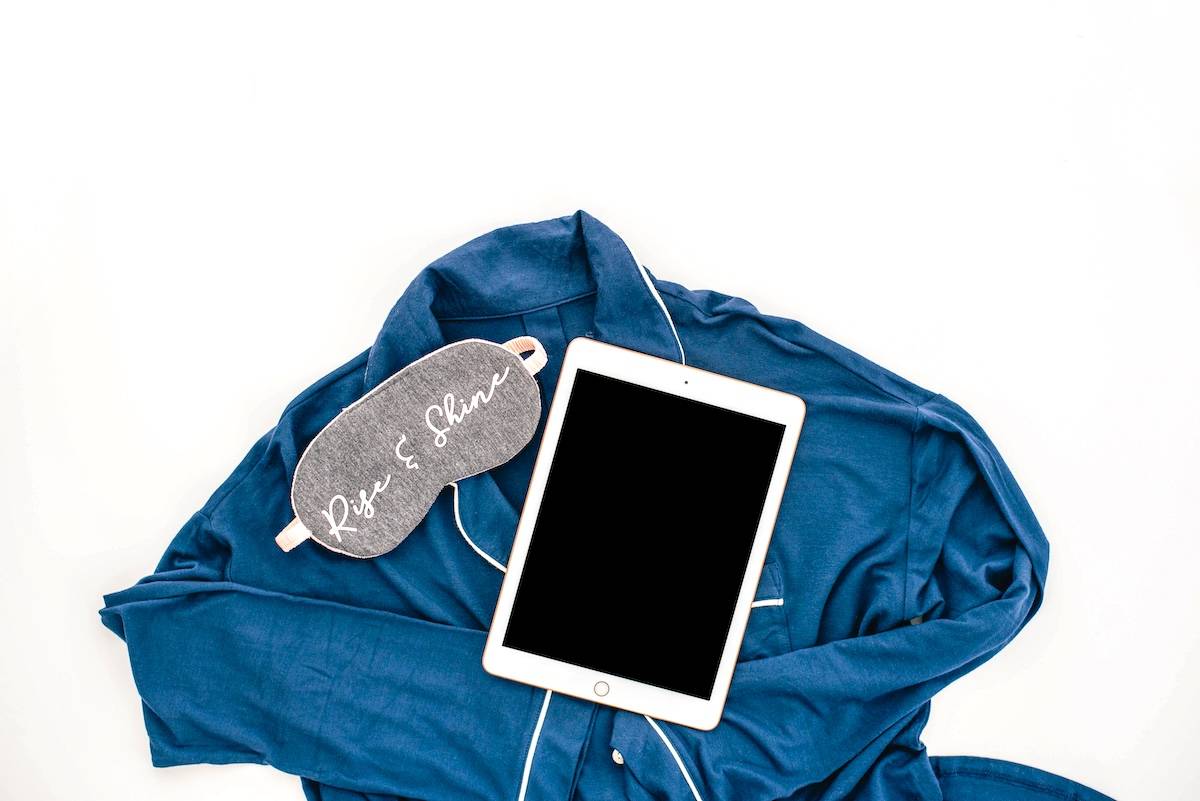 Eye mask, pjs, tablet - items needed for a realistic evening routine.
